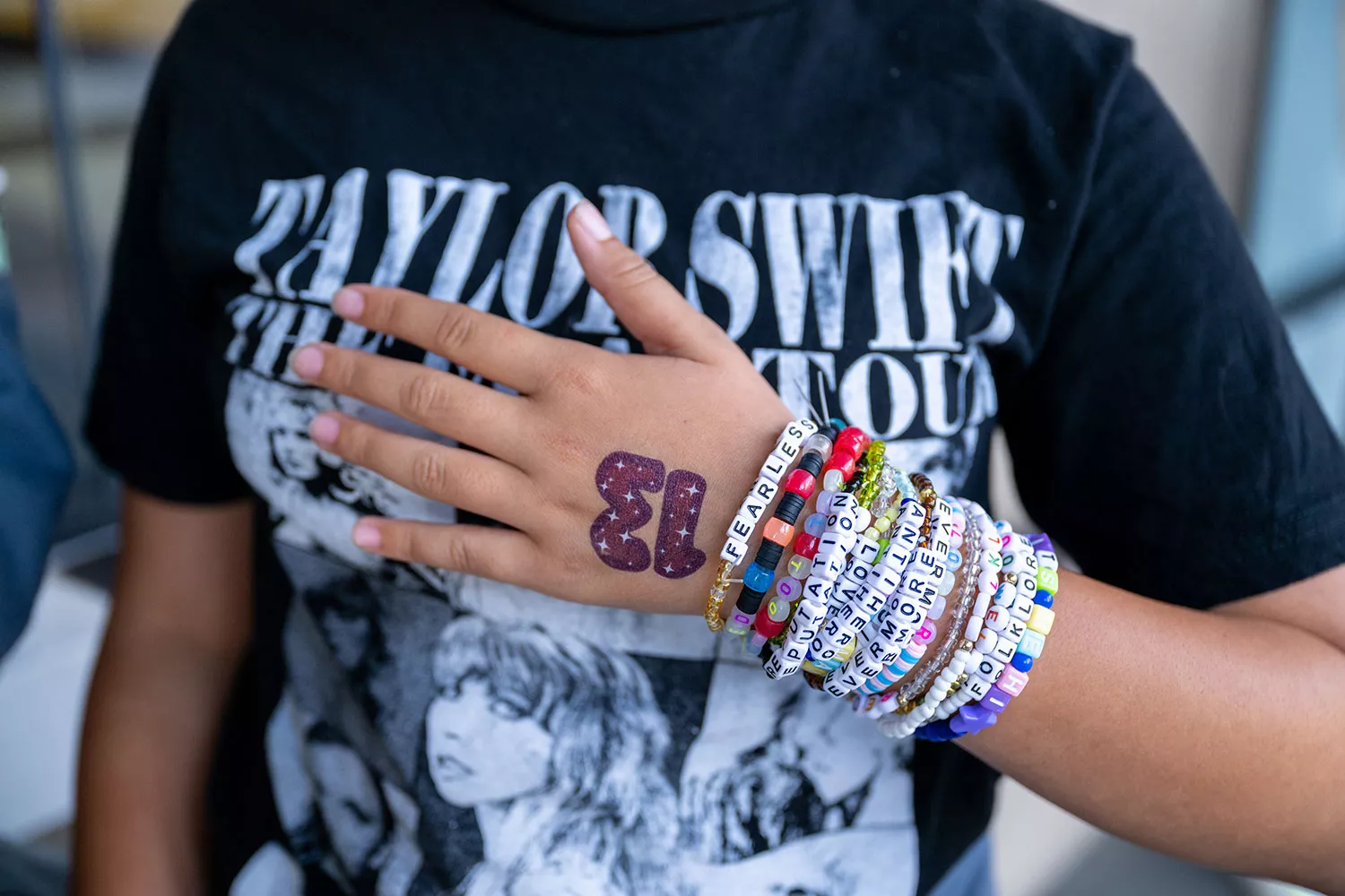 MARINA DEL REY, CALIFORNIA - OCTOBER 13: A Taylor Swift fan, friendship bracelet detail, attends the opening night theatrical release of "Taylor Swift : The Eras Tour" at AMC Marina Marketplace 6 on October 13, 2023 in Marina del Rey, California. 