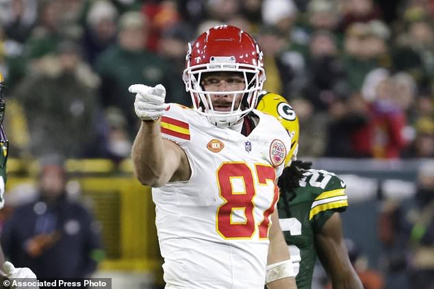 Kansas City Chiefs tight end Travis Kelce (87) signals a first down against the Green Bay Packers during the first half of an NFL football game Sunday, Dec. 3, 2023 in Green Bay, Wis. (AP Photo/Mike Roemer)